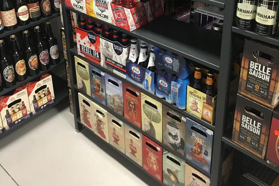Estanter&#237;as con paquetes de bebidas variadas para un cliente minorista.