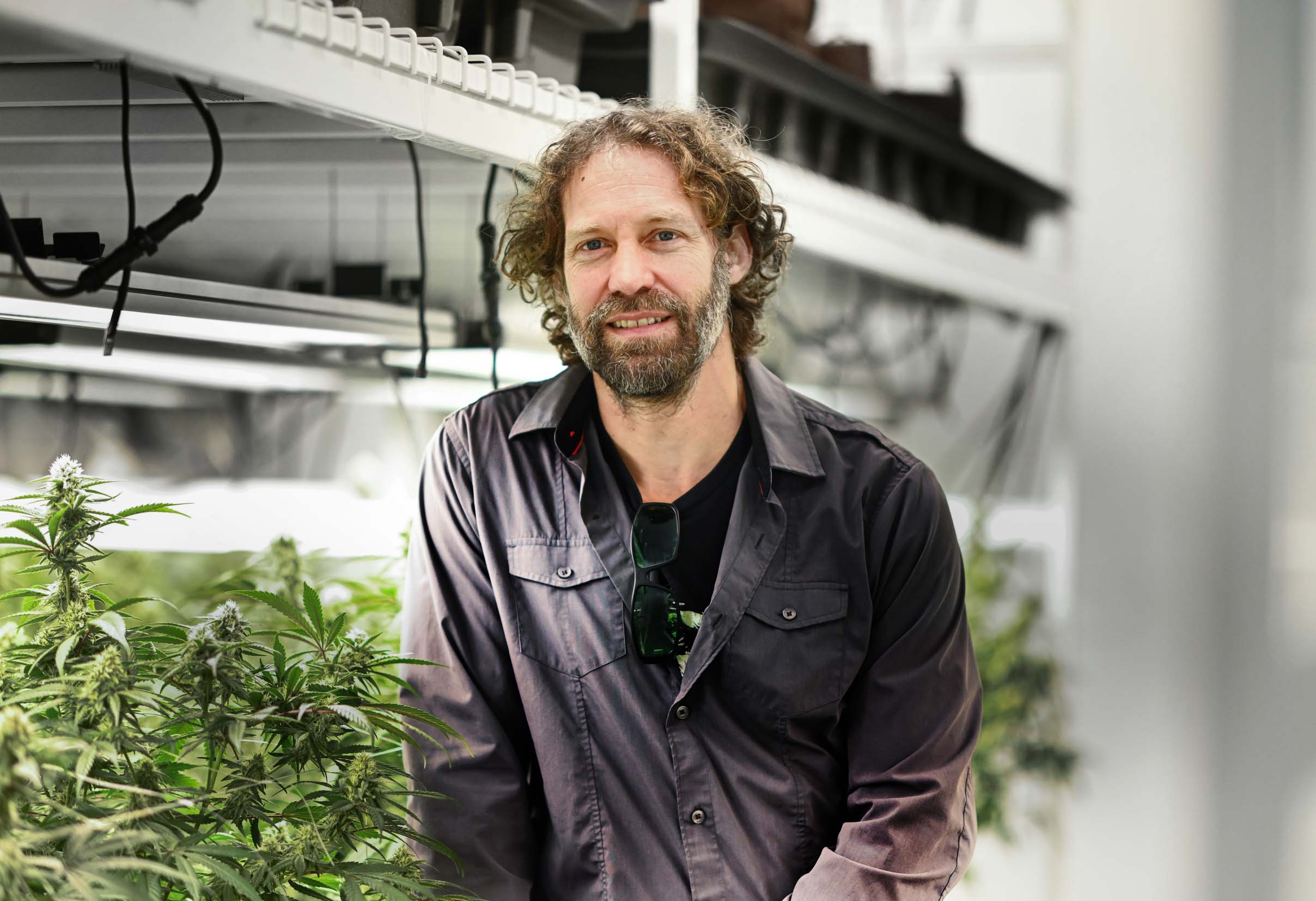 Portrait of an employee in an indoor cannabis cultivation facility.